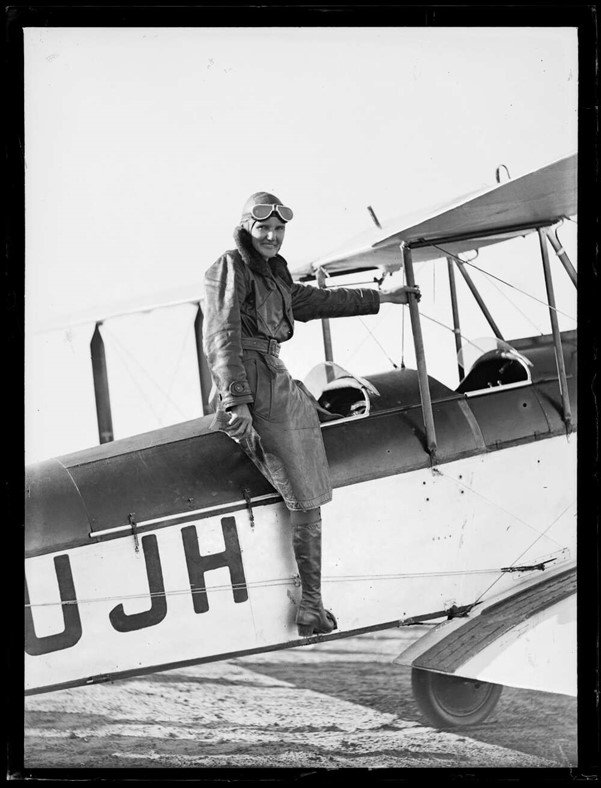 Aviatrix Irene Dean-Williams getting into her plane for her Sydney to Perth flight, Adelaide, April 1932 (Photographer Norman Victor HERFORT).